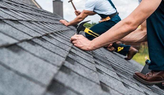 workers repairing house roof