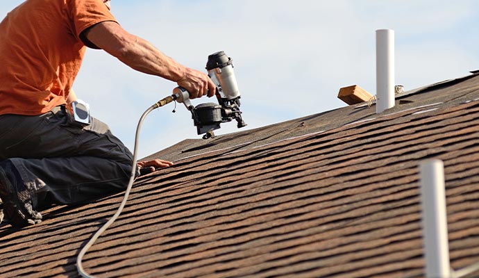 worker maintaining roof in Des Moines