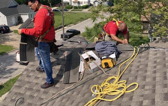 man installing roofing