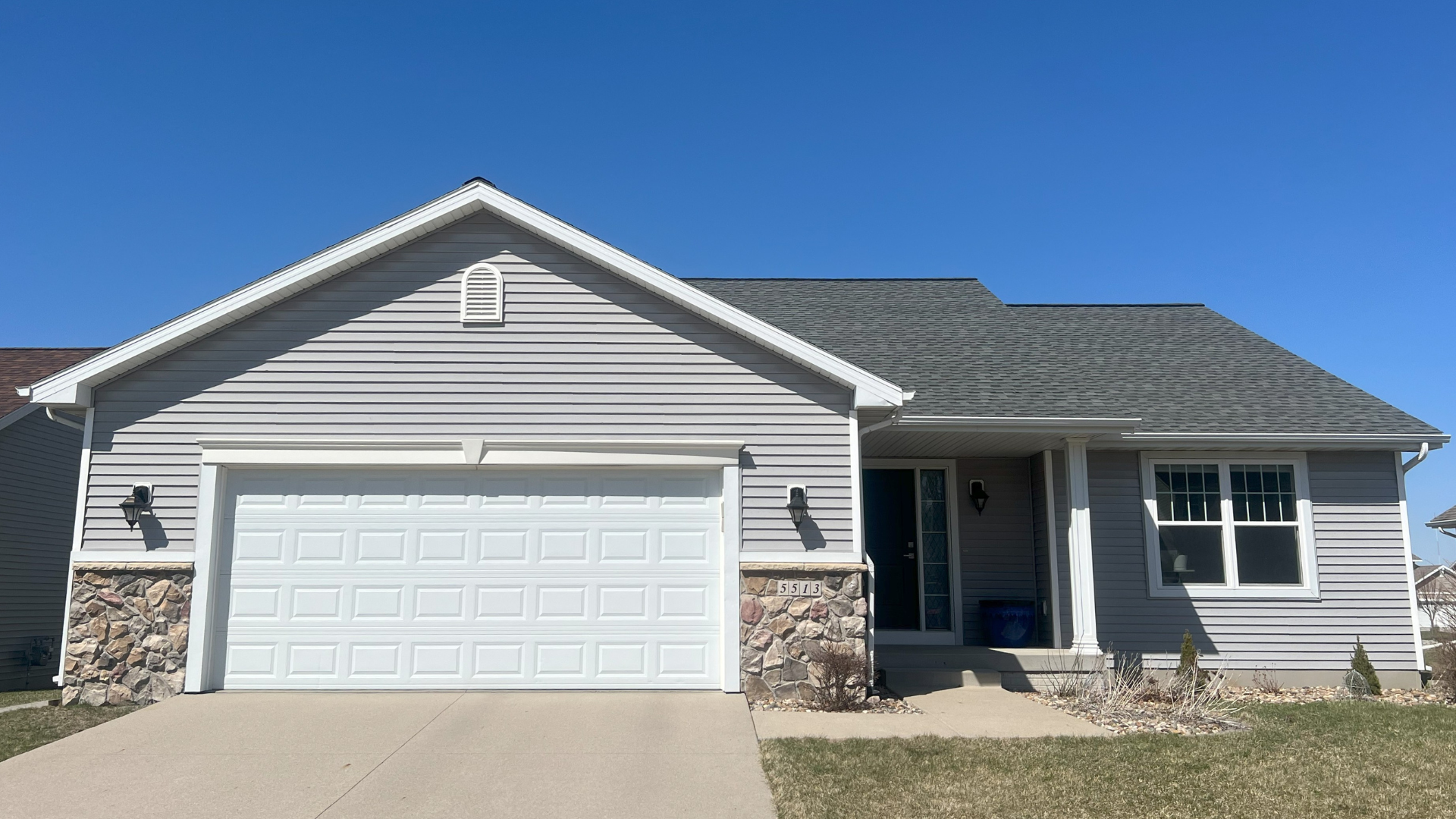 Single-story home before a full roof and siding replacement in Ames, Iowa.