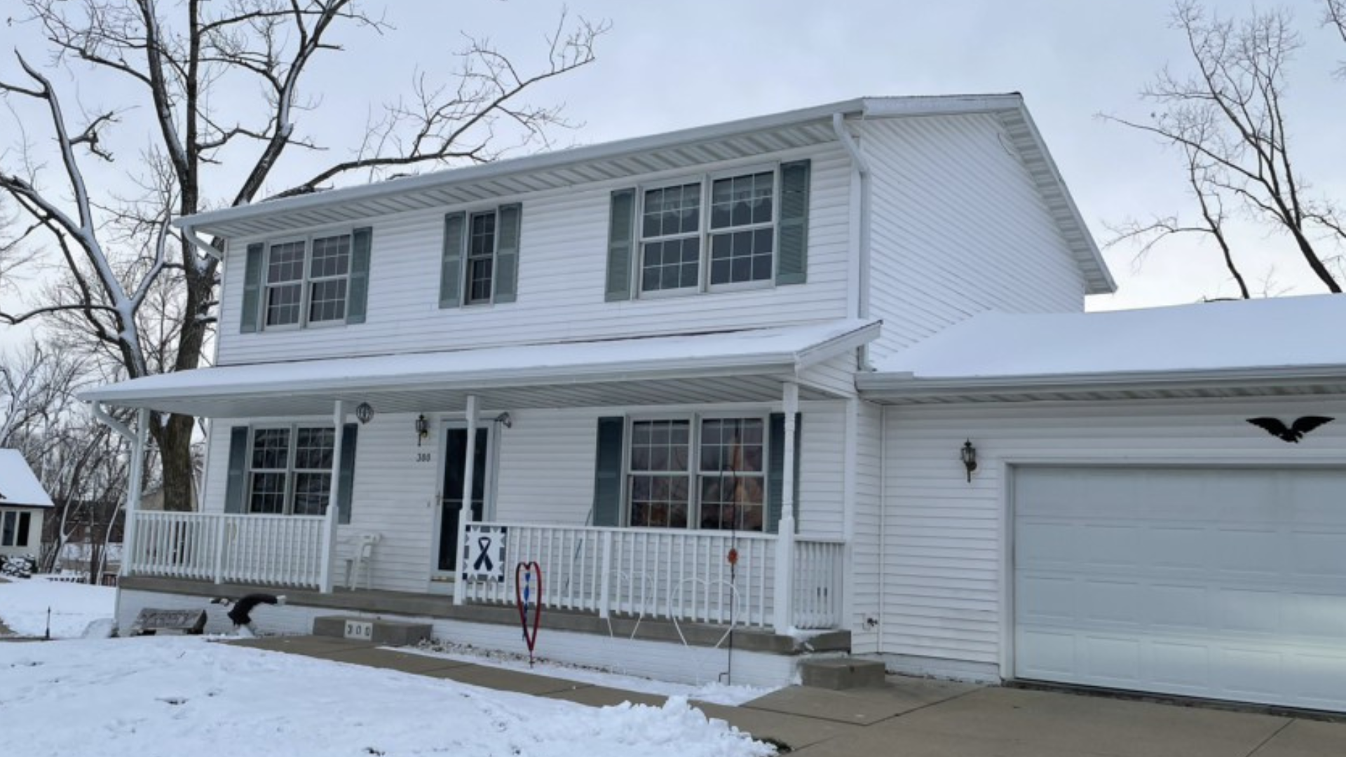 A before photo of a two-story home in Cedar Rapids before a roof and siding replacement.