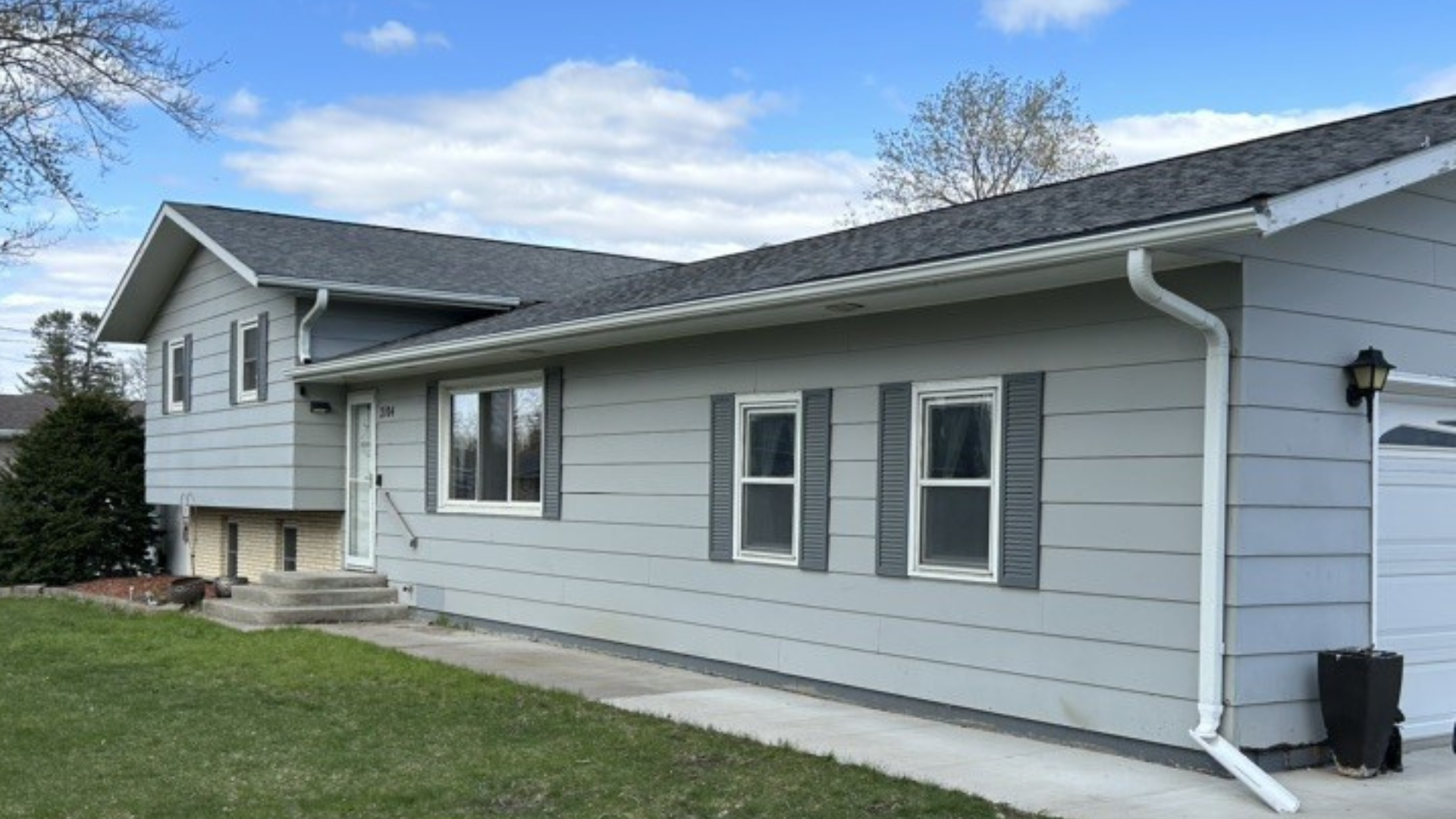 A single-story house before a full siding replacement.