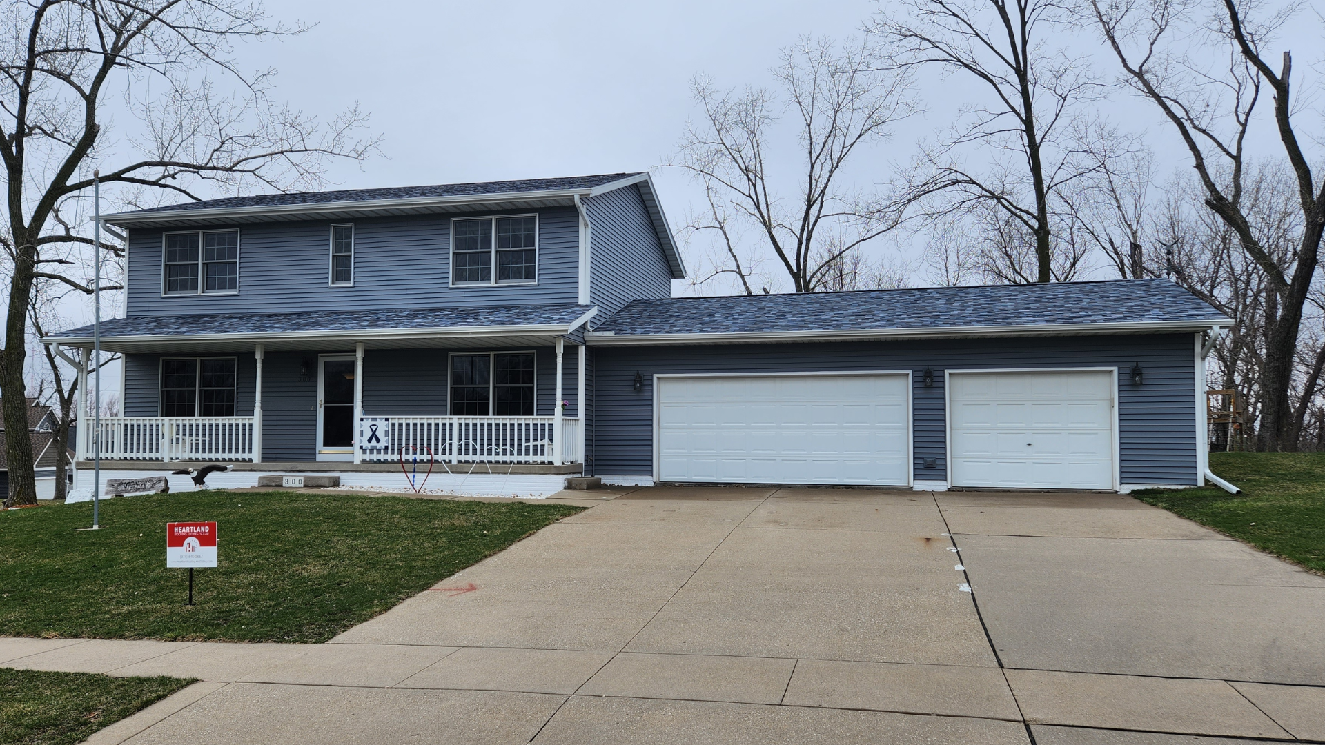 ﻿﻿An after photo of a two-story home in Cedar Rapids with Owens Corning TruDefinition Duration Designer shingles in Pacific Wave with Mastic Carvedwood siding in English Wedgewood.