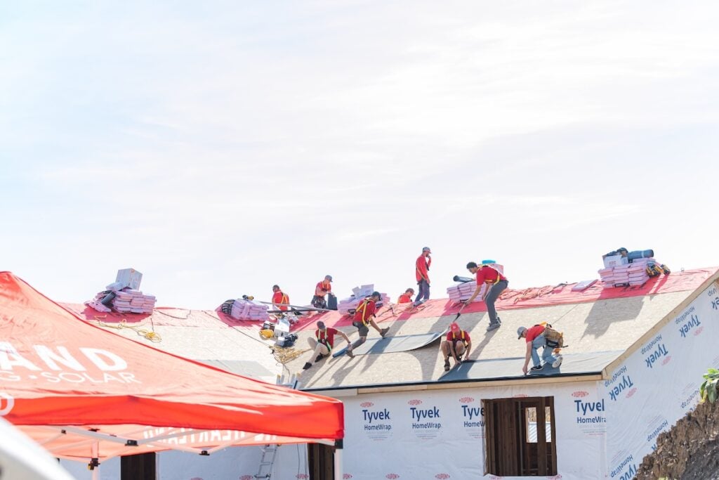 heartland roofing team working together on roofing project