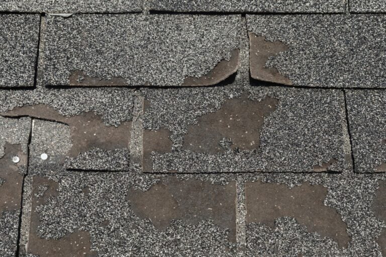 Roof in need of repair damaged asphalt roofing shingles