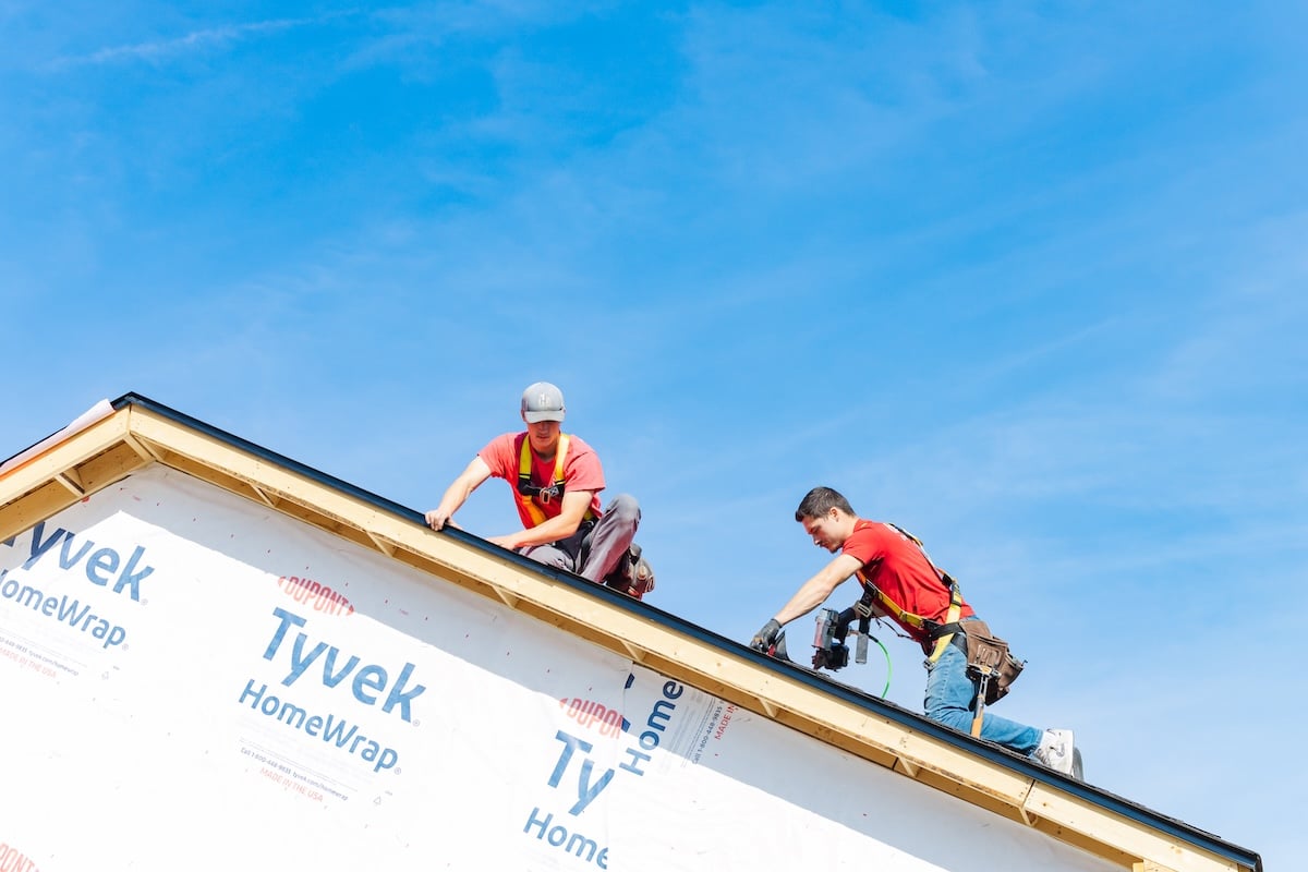 Heartland team installing shingles for roof giveaway in Winterset, Iowa.