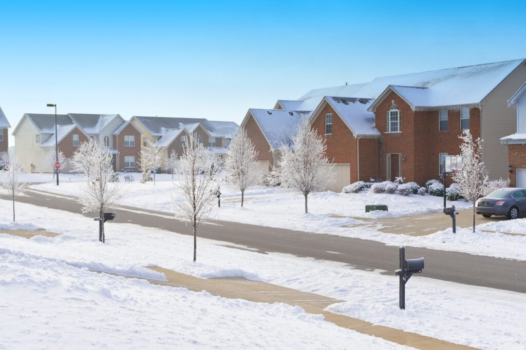 Street in an american town with snow at winter.